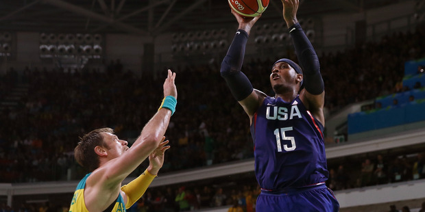 Carmelo Anthony shoots over David Andersen during a preliminary round game. Photo / Getty
