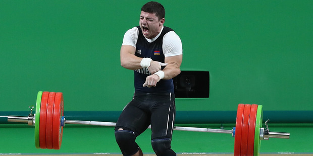 Andranik Karapetyan of Armenia was injured during the Men's 77kg Group A weightlifting contest. Photo / Getty Images