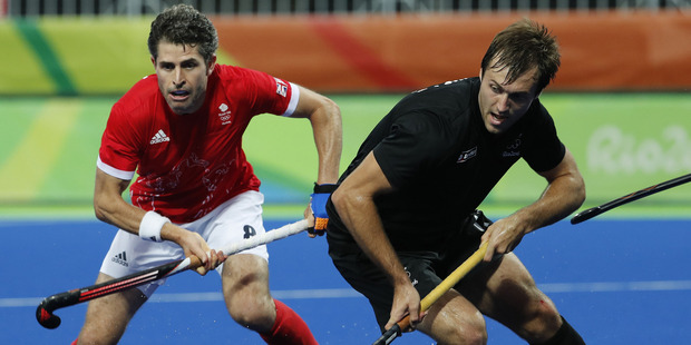 Black Sticks Nick Woods competes for the ball in the teams round robin match against Great Britain. Photo / AP