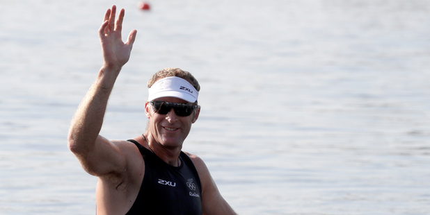 Mahe Drysdale waves after winning his heat in the men's single sculls at the Rio Olympics. Photo / AP