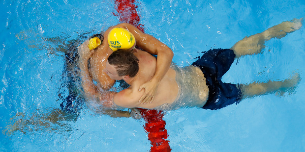 Australia's Kyle Chalmers gets a hug from Cameron McEvoy after winning the 100m freestyle finals. Photo / AP