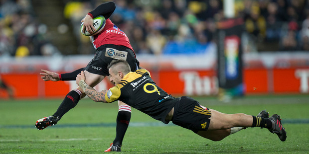 Hurricanes halfback TJ Perenara makes a tackle on Lions wing Ruan Combrinck during the 2016 Investec Super Rugby final at Westpac Stadium in Wellington. Photo / Mark Mitchell
