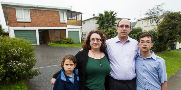 The Henk family, from left - Hazel, 8, Mandy, Chris and Elliott, 14, outside their former rental property in Mairangi Bay.