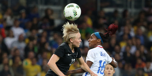 New Zealand's Betsy Hassett, left, goes up for a header in her side's 3-0 defeat to France today. Photo / AP.