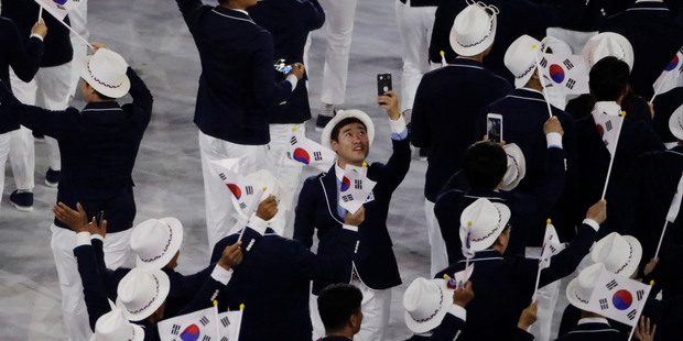 Members of team South Korea arrive during the opening ceremony. Photo / AP