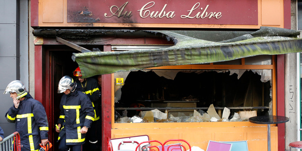 Firefighters leave the bar where a fire broke in Rouen, western France. Photo / AP