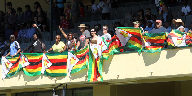 Zimbabweans wave flags during the 36th over of the test cricket match between New Zealand and Zimbabwe in Bulawayo. Picture / AP