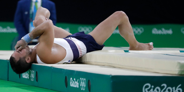 France's Samir Ait Said holds his leg after injuring it while performing on the vault during the artistic gymnastics men's qualification. Photo / AP