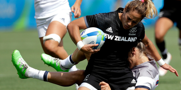 New Zealand's Kayla McAlister, front, tackled by France's Caroline Ladagnous, during the women's rugby sevens match at the Summer Olympics in Rio de Janeiro. Photo / AP
