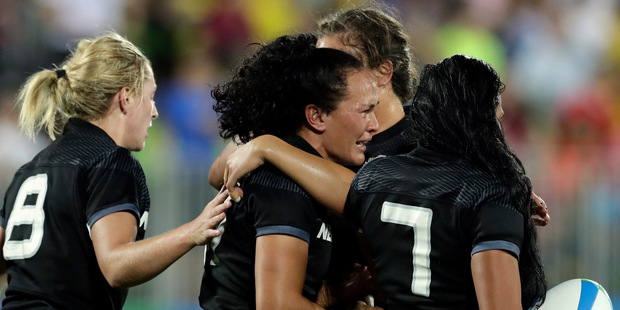 Portia Woodman, middle, is comforted by teammates after New Zealand were beaten by Australia in the women's rugby sevens gold medal match. Photo / AP.