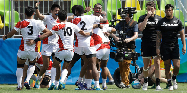 Japan's players celebrate after winning the men's sevens match against New Zealand. Photo / AP