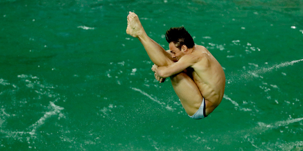 Brit Tom Daley takes part in a training session after the water in the diving pool turned green. Photo / AP