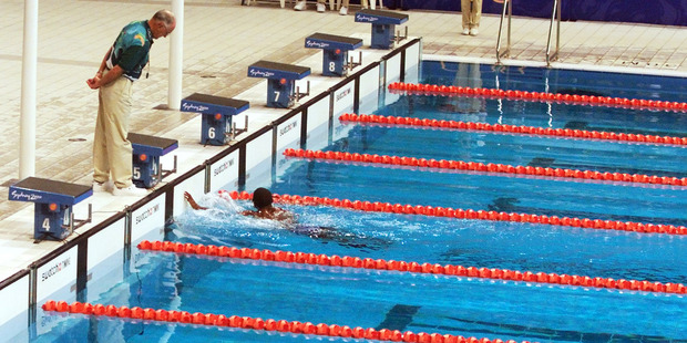 Swimming judges monitor the finish of Eric Moussambani as he competes alone in the first heat of the men's 100m freestyle at the 200 Sydney Olympics. Photo / AP