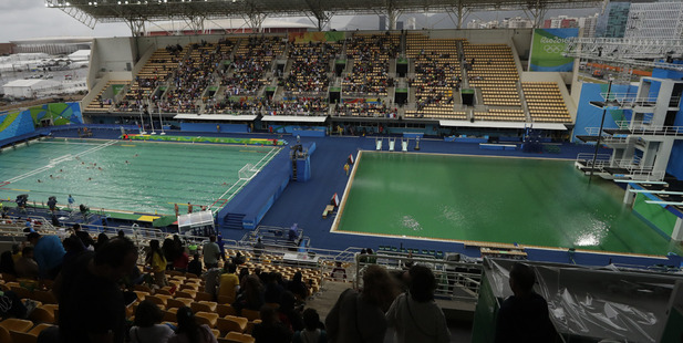 The water of the diving pool at right appears a murky green as the water polo pool at left appears a greener colour than the previous day. photo / AP