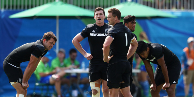 The New Zealand sevens team look dejected following their shock defeat to Japan. Photo /Getty