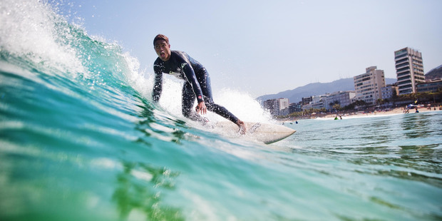 A surfer rides a wave at Ipanema Beach. Photo / AP