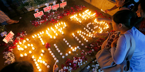 Human rights activists light candles for the victims of extra-judicial killings around the country in the wake of the 'War on Drugs' campaign by Philippine President Rodrigo Duterte. Photo / AP