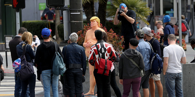 People gather around a statue of republican presidential nominee Donald Trump in San Francisco. Photo / Getty Images