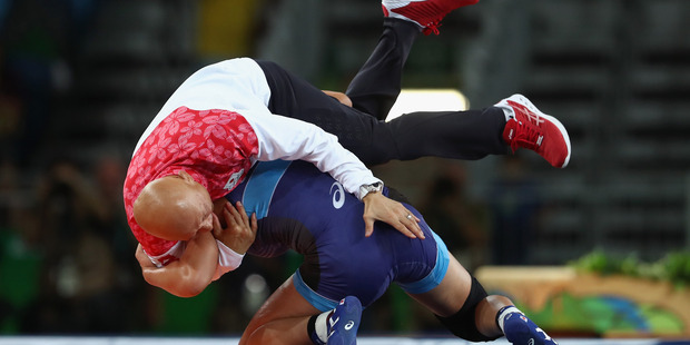 The Japanese gold medallist threw her coach to the ground before parading him around the arena on her shoulders. Photo / Getty Images