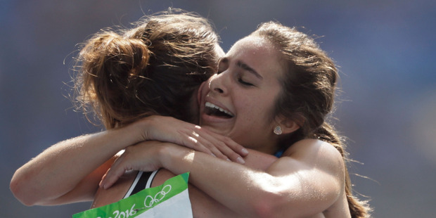 New Zealand's Nikki Hamblin, left, and United States' Abbey D'Agostino embrace after completing their heat in the Olympic 5000m. Photo / AP