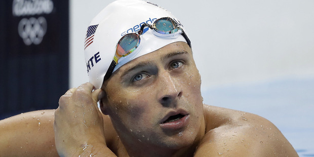 Lochte and three other American swimmers were robbed at gunpoint early Sunday, Aug. 14, by thieves posing as police officers who stopped their taxi and took their money and belongings. Photo / AP