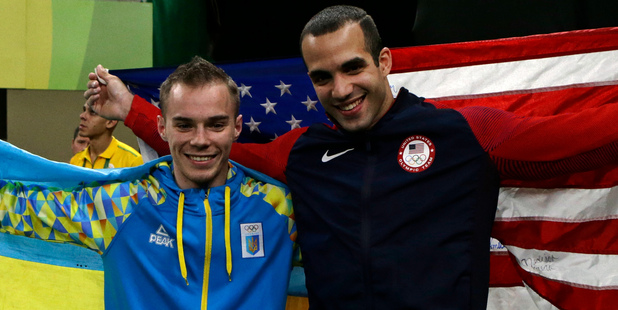 Ukraine's Oleg Verniaiev, left, and silver medallist United States' Danell Leyva celebrate with their national flags. Photo / AP