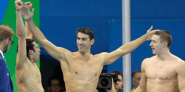 United States' Michael Phelps celebrates with teammates after winning gold in the men's 4 x 100-meter medley relay final. Photo / AP