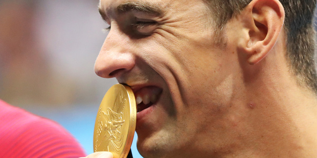 United States' Michael Phelps kisses his gold medal for the men's 4 x 100-meter medley relay final. Photo / AP