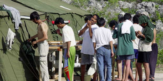 Men shave, brush their teeth and prepare for the day at a refugee camp on the Island of Nauru. Photo / AP