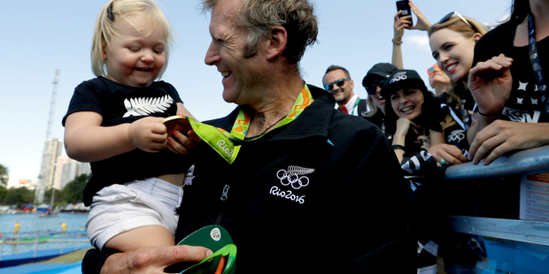 Mahe Drysdale, of New Zealand, holds his daughter, Bronte Drysdale, after winning gold in the men's rowing single sculls final during the 2016 Summer Olympics in Rio de Janeiro, Brazil, Saturday, Aug.