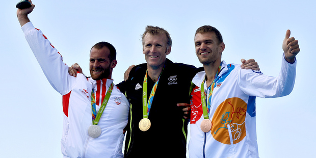 Silver medalist Damir Martin, of Croatia, left, bronze medalist Ondrej Synek, of the Czech Republic, right and gold medalist Mahe Drysdale, of New Zealand. Photo / AP.