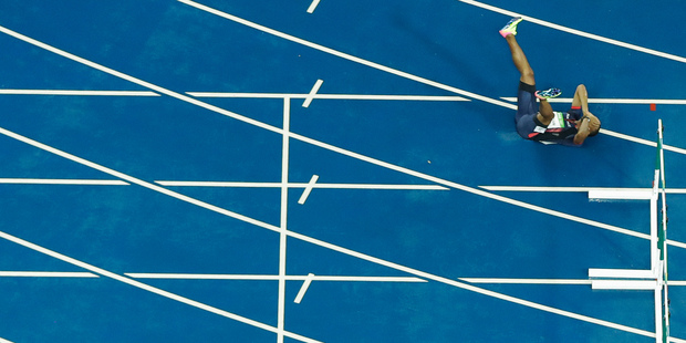 France's Wilhem Belocian lays on the track after his false start in a 110m hurdles heat. Photo / AP