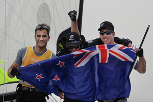 Peter Burling (right) celebrates with team mate Blair Tuke (left) and their coach after winning the 49er men gold medal the 2016 Summer Olympics in Rio de Janeiro, Brazil. Photo/AP