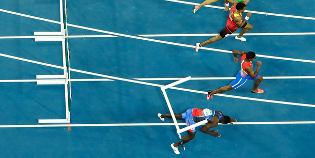 Haiti's Jeffrey Julmis falls down after hitting a hurdle in the 110m semifinals. Photo / AP
