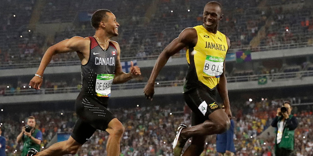 Canada's Andre De Grasse, left, and Jamaica's Usain Bolt during the men's 200-meter semifinal. Photo / AP
