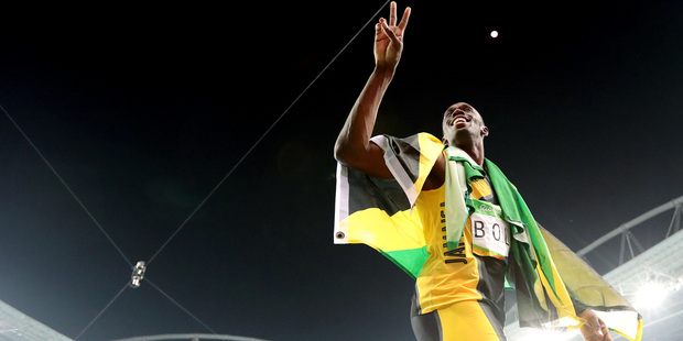 Usain Bolt celebrates winning the gold medal in the men's 4x100-meter relay. Photo / AP