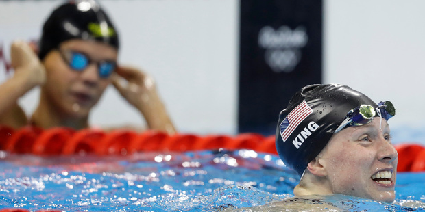 Russia's Efimova, left, looks on as United States' Lilly King celebrates after winning the gold medal. Photo / AP