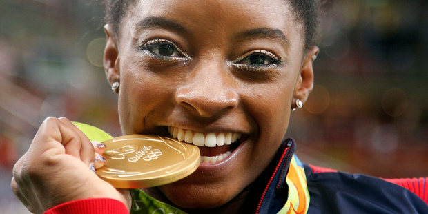 Simone Biles of the United States poses with her "gold" medal after the artistic gymnastics women's individual final. Photo / AP