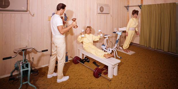 Guests working out in the South Winds Motel gym with a fitness trainer. Photo / Getty Images
