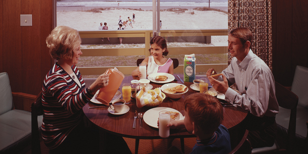 A family eats breakfast together while on holiday at the Grand Motel in Myrtle Beach, South Carolina. Photo / Getty Images