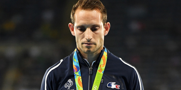 Silver medalist Renaud Lavillenie reacts during the medal ceremony for the men's pole vault. Photo / Getty