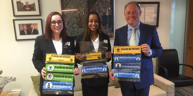 TLinks company directors Alex Ough Dealy (left) and Nikara Tikaram from Kerikeri High School show their bumper stickers to Associate Minister for Transport Craig Foss.