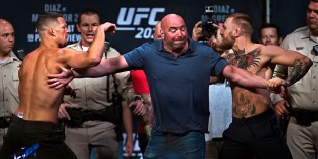 Welterweight Nate Diaz, left, is held back by UFC president Dana White from opponent Conor McGregor during the UFC 202 weigh-ins. Photo / AP