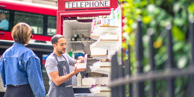 Ben Spier, owner of Spier Salads, fills a customer order at his converted red telephone box in Bloomsbury Square in London. Photo / Bloomberg
