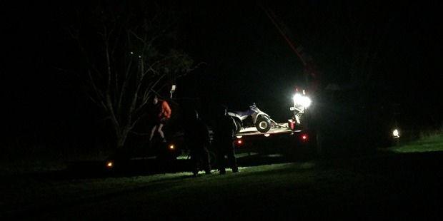 Tow truck drivers lifted the quad bike out of the creek this evening. Photo / Supplied