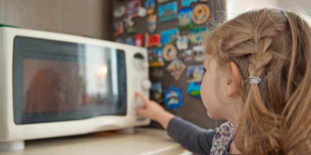 Despite being a common kitchen appliance, a radiation expert advises keeping children away from microwaves. Photo / Getty
