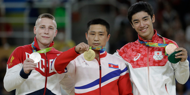 Russia's Denis Albyazin and Japan's Kenzo Shirai smiles on the podium contrasted dramatically with the glum expression of the North Korean athlete. Photo / AP