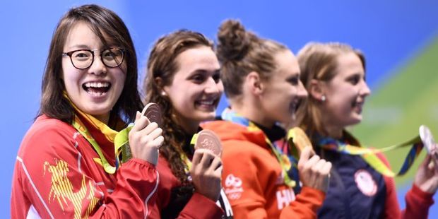 Fu Yuanhui (L) became a social media sweetheart for claiming she had used "primeval force" in a semifinal. Photo / AFP