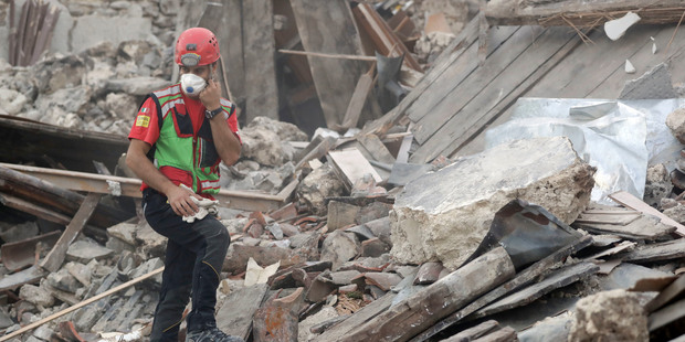 Rescuers search through debris following an earthquake in Pescara Del Tronto, Italy. Photo / AP