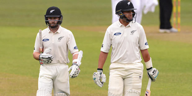 Kane Williamson and Ross Taylor of New Zealand walk off for a early lunch due to bad light during day 2. Photo / Getty Images.